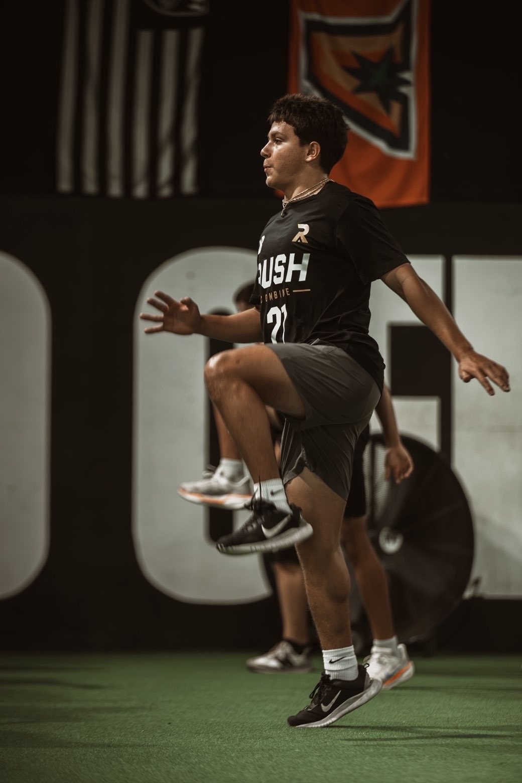 Athlete mid high-knee drill during Rush Combine