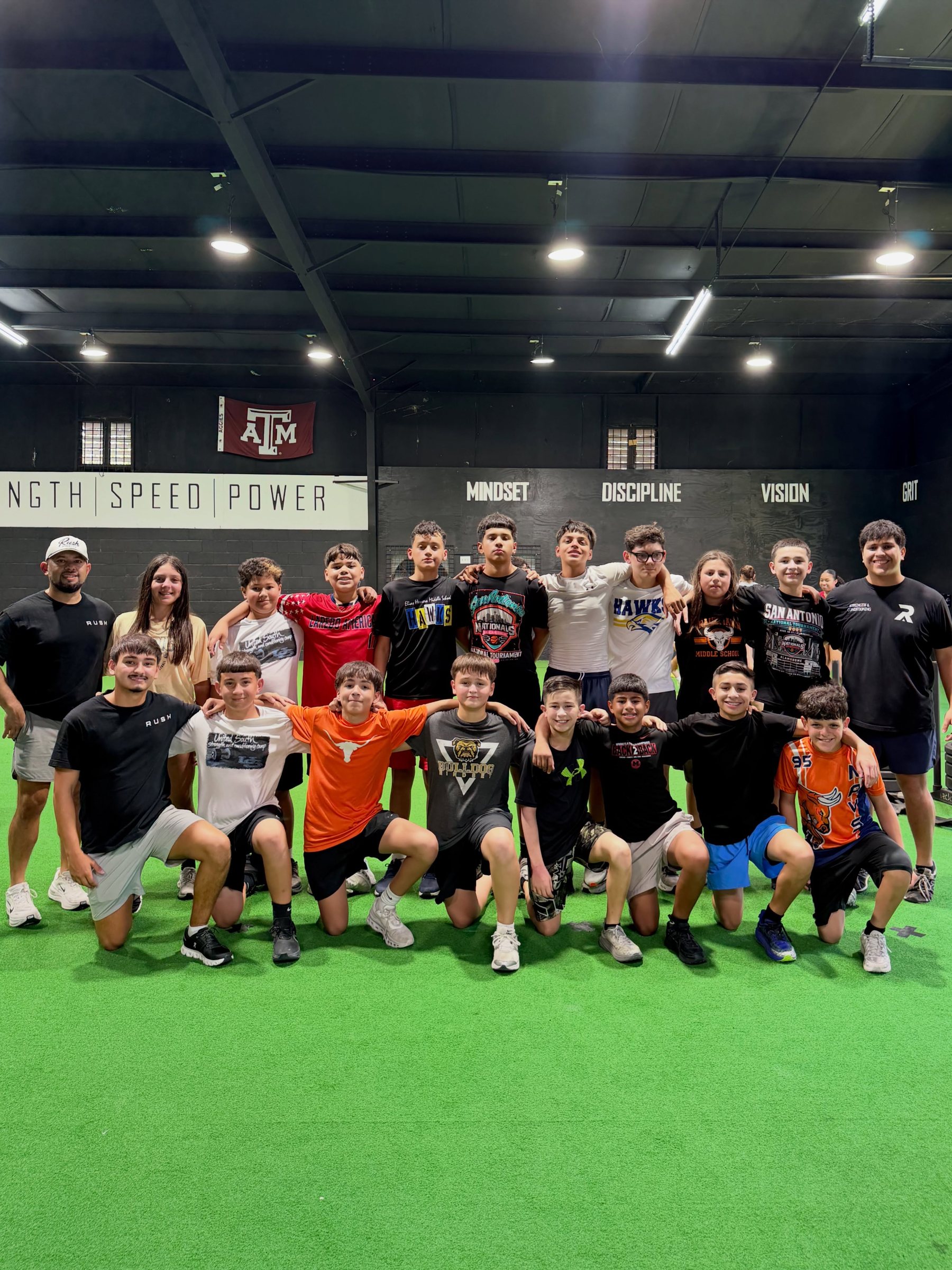 MS/HS athletes and coach at Rush Athletics Laredo, Pillars wall in background