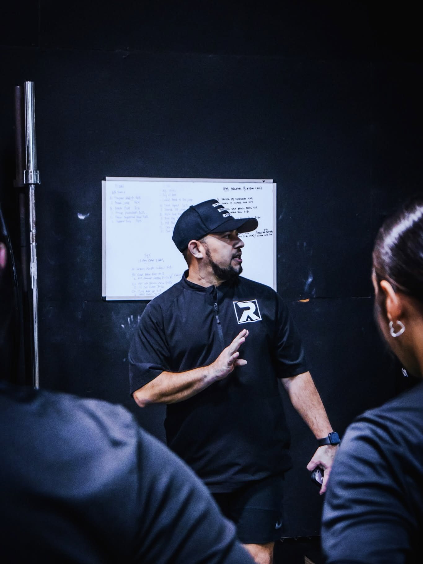 Coach breaking down programming for athletes at Rush Athletics Laredo